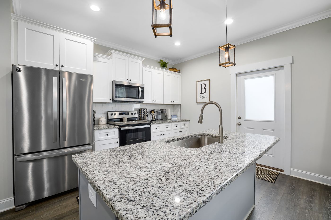 Renovated home kitchen with granite island